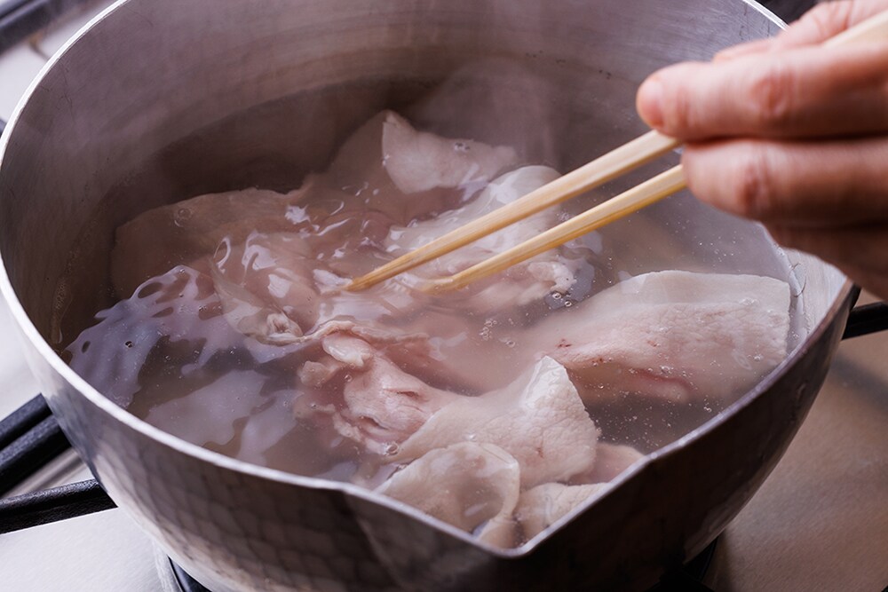 ２の素麺を茹でた湯を沸かし、豚肉を一度に入れ、箸でザッと混ぜ、火を止める。